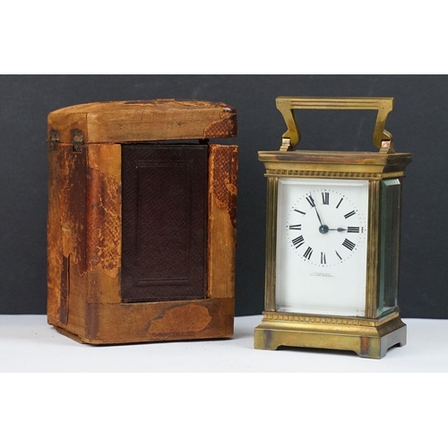 219 - An antique French brass cased carriage clock with bevelled glass panels, retailer marked for Gaydon ... 