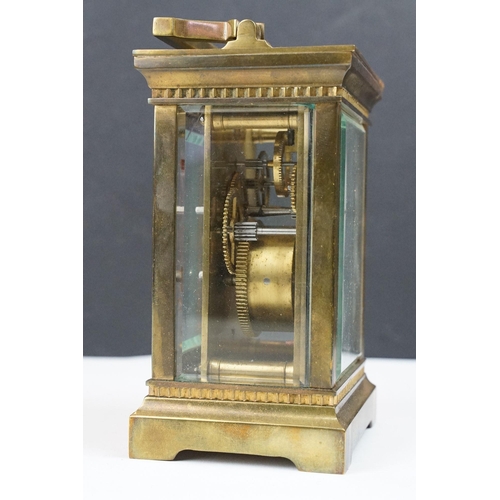 219 - An antique French brass cased carriage clock with bevelled glass panels, retailer marked for Gaydon ... 