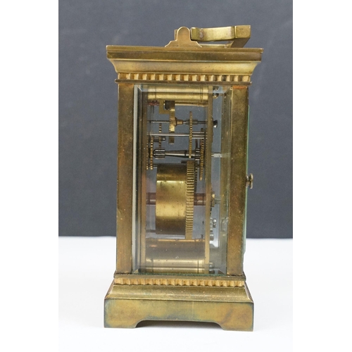 219 - An antique French brass cased carriage clock with bevelled glass panels, retailer marked for Gaydon ... 