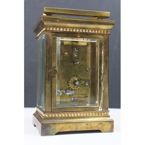 219 - An antique French brass cased carriage clock with bevelled glass panels, retailer marked for Gaydon ... 