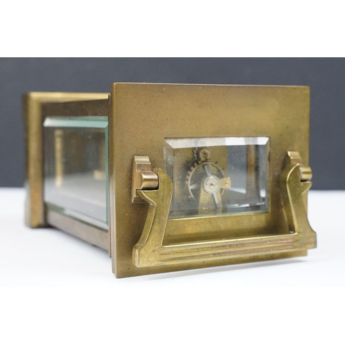 219 - An antique French brass cased carriage clock with bevelled glass panels, retailer marked for Gaydon ... 