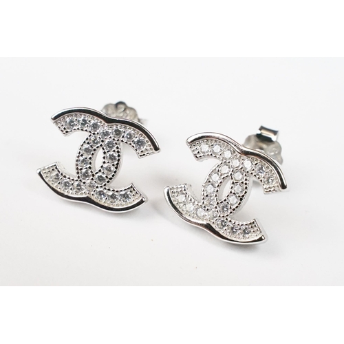 229 - Pair of silver and CZ designer style stud earrings