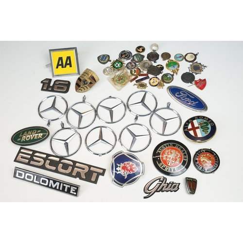 324 - A collection of car badges to include Mercedes, Land Rover, Porsche and Rover examples together with... 