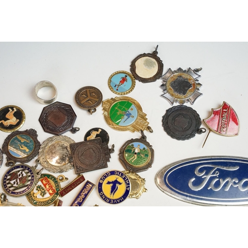 324 - A collection of car badges to include Mercedes, Land Rover, Porsche and Rover examples together with... 