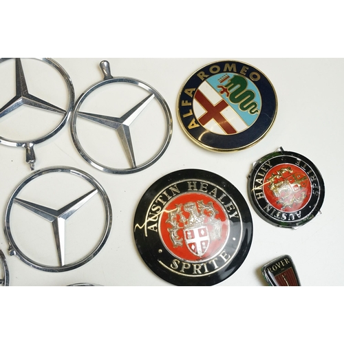 324 - A collection of car badges to include Mercedes, Land Rover, Porsche and Rover examples together with... 