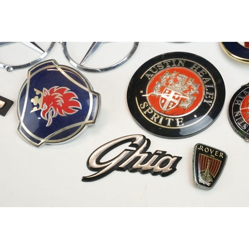 324 - A collection of car badges to include Mercedes, Land Rover, Porsche and Rover examples together with... 