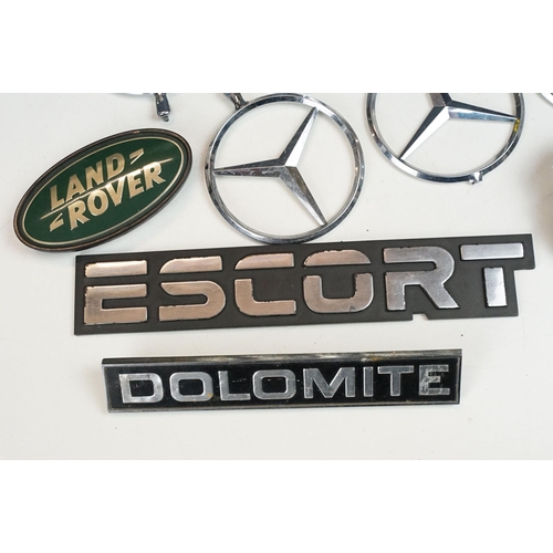 324 - A collection of car badges to include Mercedes, Land Rover, Porsche and Rover examples together with... 