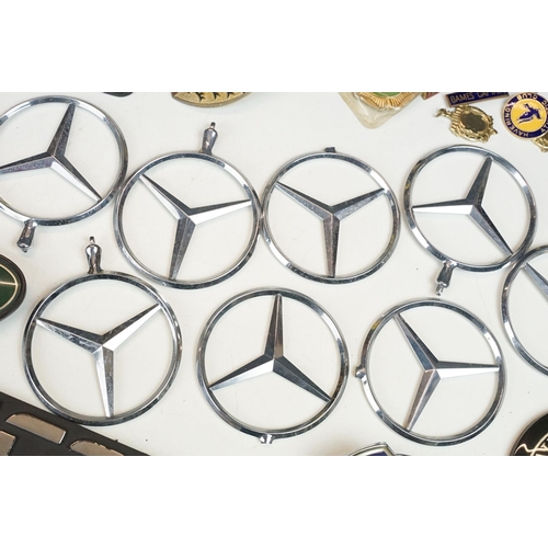 324 - A collection of car badges to include Mercedes, Land Rover, Porsche and Rover examples together with... 