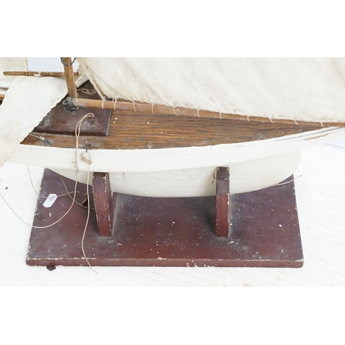 329 - Vintage wooden decked pond yacht, hand painted, L 60cm, with stand