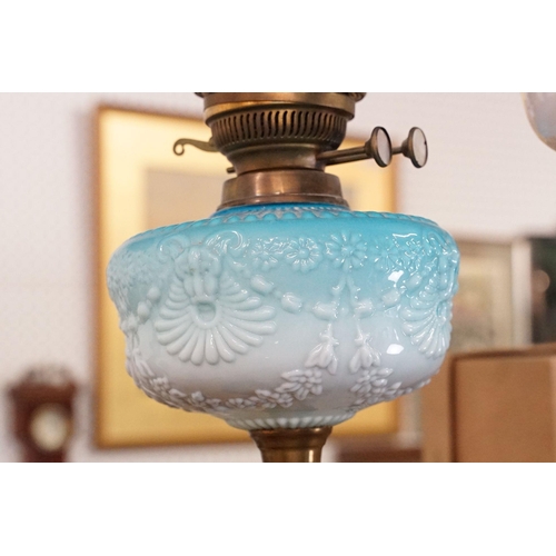 333 - Group of four early 20th century oil lamps to include opaque coloured glass, coloured glass and whit... 