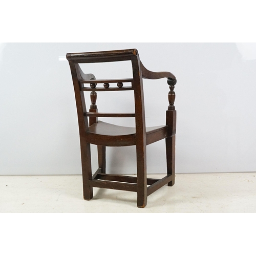 335 - 19th century mahogany child's chair with scroll arms, carved ball and bar back, curved solid seat on... 