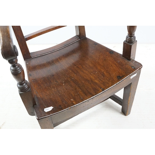 335 - 19th century mahogany child's chair with scroll arms, carved ball and bar back, curved solid seat on... 