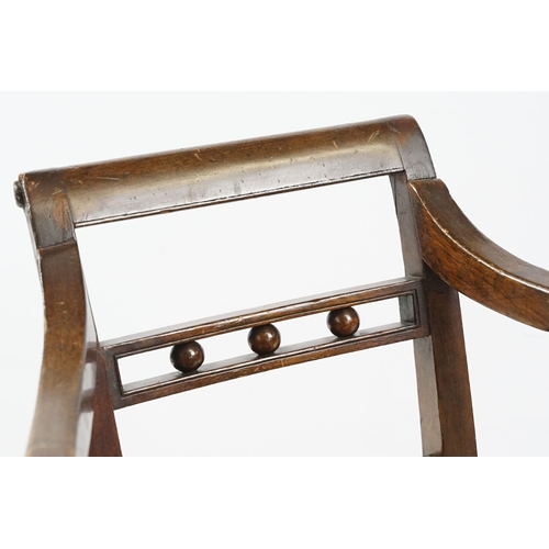 335 - 19th century mahogany child's chair with scroll arms, carved ball and bar back, curved solid seat on... 