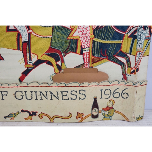 170 - Vintage Guinness advertising board printed with the Bayeux tapestry holding Guinness glasses, marked... 