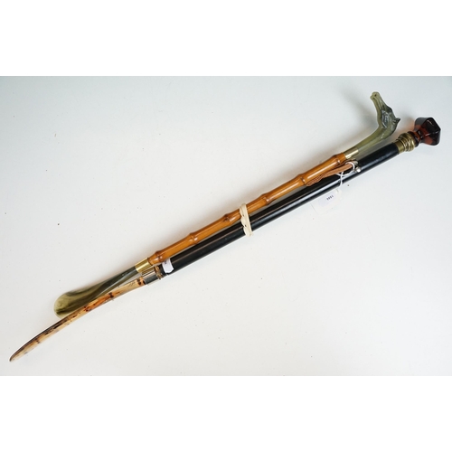 278 - A collection of eleven vintage riding crops to include leather, bamboo and wooden examples with vari... 