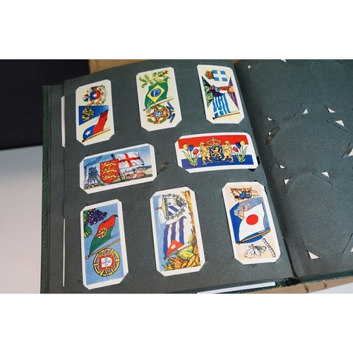 293 - A collection of cigarette card sets within six albums together with loose sets of cigarette and trad... 