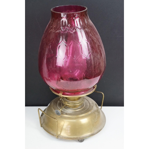 36 - Collection of Victorian oil lamps to include two large cranberry glass and clear chimney examples, t... 