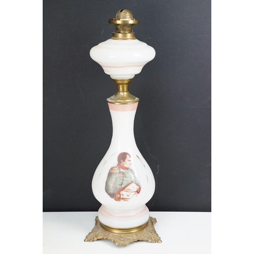 36 - Collection of Victorian oil lamps to include two large cranberry glass and clear chimney examples, t... 