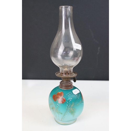 36 - Collection of Victorian oil lamps to include two large cranberry glass and clear chimney examples, t... 