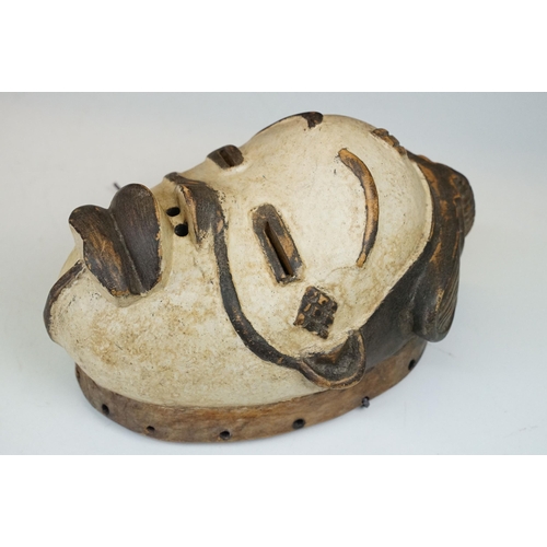 434 - Two tribal art carved and painted wooden masks together with an Ivory Coast West African mask exampl... 