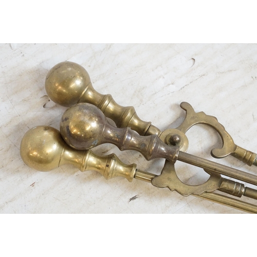 440 - Assortment of brass to include twelve stair rods and brackets, fire side utensils and fire dogs