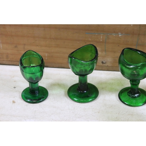 405 - Collection of optical glass eye baths to include green and clear glass examples (1box)