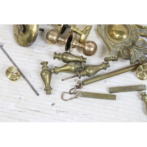 411 - Selection of brass items to include door knobs, scrolled furniture pediments, Salter hanging weighin... 