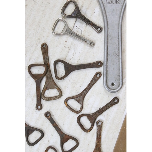 413 - Large assortment of vintage cast iron crown top bottle openers many with branded names to include Cu... 