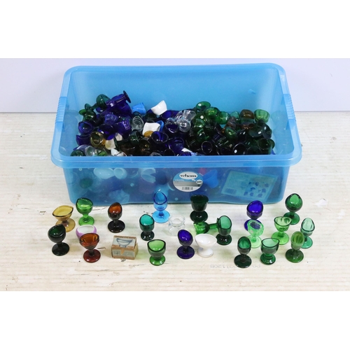 426 - Large collection of antique and vintage mixed coloured and shape glass eye baths to include ceramic ... 