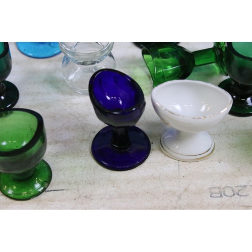 426 - Large collection of antique and vintage mixed coloured and shape glass eye baths to include ceramic ... 