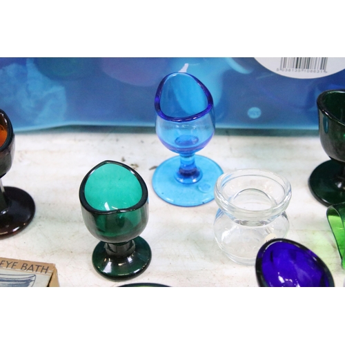 426 - Large collection of antique and vintage mixed coloured and shape glass eye baths to include ceramic ... 