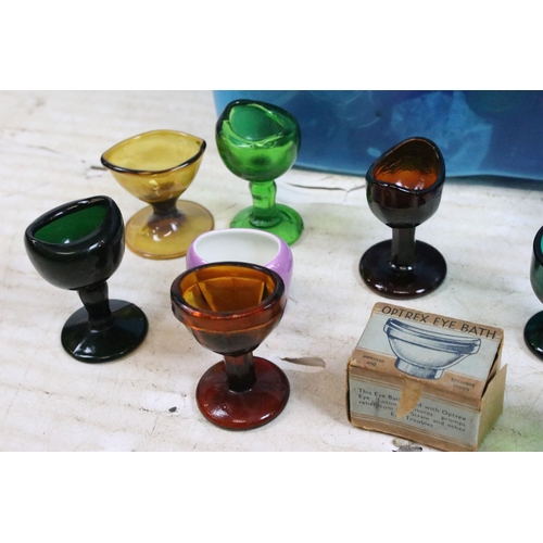 426 - Large collection of antique and vintage mixed coloured and shape glass eye baths to include ceramic ... 