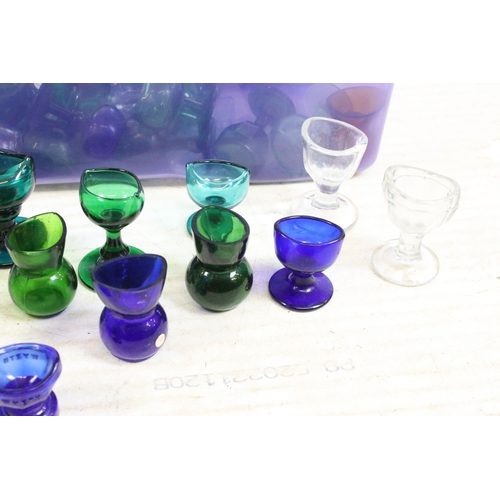 426A - Large selection of antique and vintage coloured mixed shape glass eye baths to include blue, green a... 