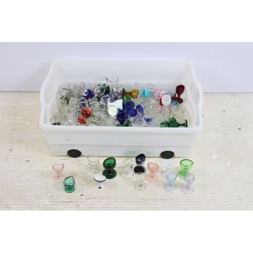 427 - Large collection of antique and vintage mixed coloured and shape glass eye baths to include milk gla... 