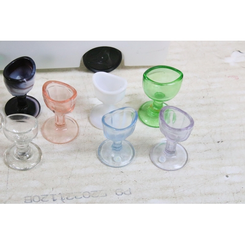 427 - Large collection of antique and vintage mixed coloured and shape glass eye baths to include milk gla... 