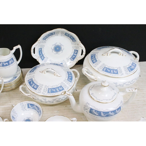 77 - Coalport 'Revelry' blue border part dinner service set to include tea pot, round serving dish, beake... 