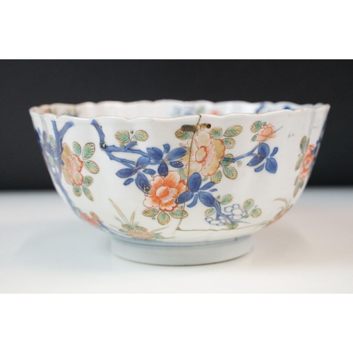 19 - Two Chinese Qing dynasty bowls to include a blue and white painted bowl depicting figures in a garde... 