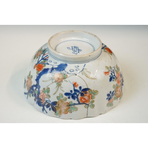 19 - Two Chinese Qing dynasty bowls to include a blue and white painted bowl depicting figures in a garde... 