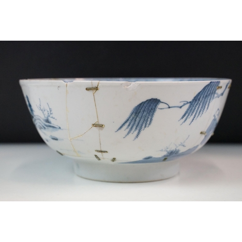 19 - Two Chinese Qing dynasty bowls to include a blue and white painted bowl depicting figures in a garde... 