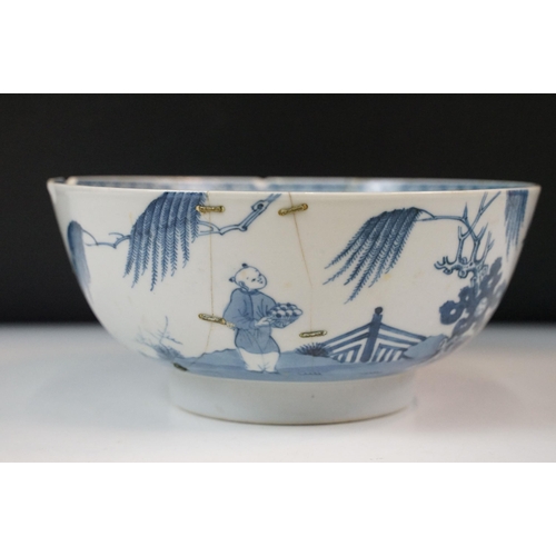 19 - Two Chinese Qing dynasty bowls to include a blue and white painted bowl depicting figures in a garde... 