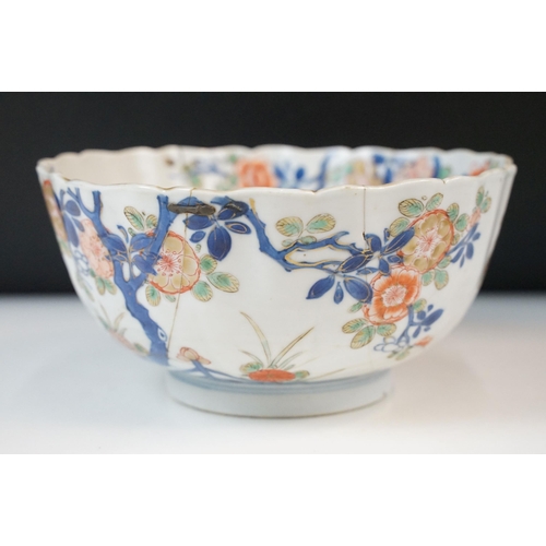 19 - Two Chinese Qing dynasty bowls to include a blue and white painted bowl depicting figures in a garde... 