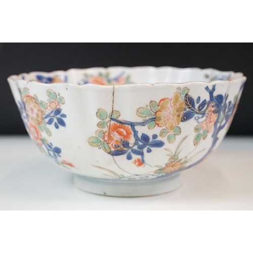 19 - Two Chinese Qing dynasty bowls to include a blue and white painted bowl depicting figures in a garde... 