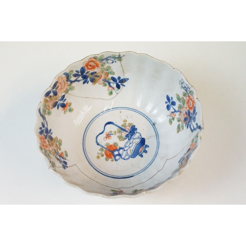 19 - Two Chinese Qing dynasty bowls to include a blue and white painted bowl depicting figures in a garde... 