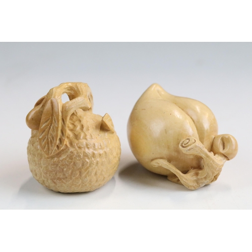 Two carved wooden netsuke figures of fruit