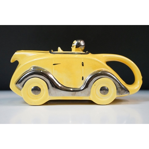 22 - Art Deco ceramic racing car teapot in yellow and chrome, signed D to base