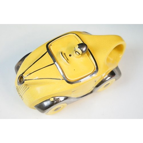 22 - Art Deco ceramic racing car teapot in yellow and chrome, signed D to base