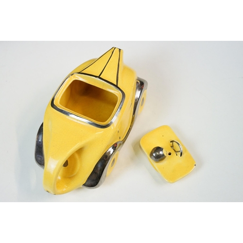 22 - Art Deco ceramic racing car teapot in yellow and chrome, signed D to base