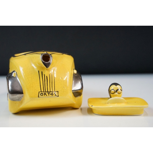 22 - Art Deco ceramic racing car teapot in yellow and chrome, signed D to base