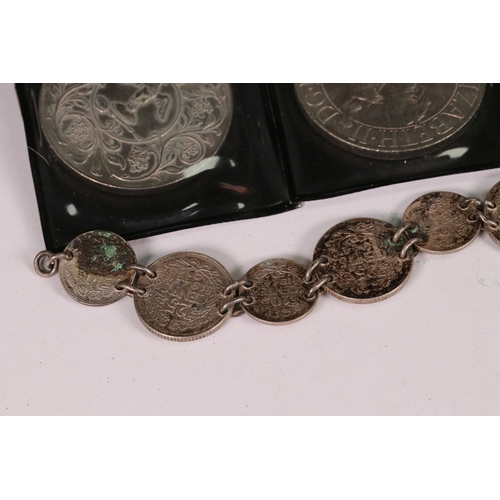 154 - A small collection of commemorative crown and £5 coins together with two medallions and a coin brace... 