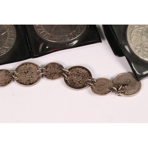 154 - A small collection of commemorative crown and £5 coins together with two medallions and a coin brace... 